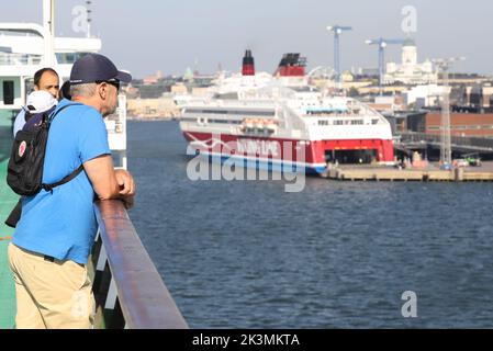 Helsinki, Finland - August 20, 2022: Passengers on deck viewing the city when the crusieferry Silja Serenad arriving from Stockholm. Stock Photo