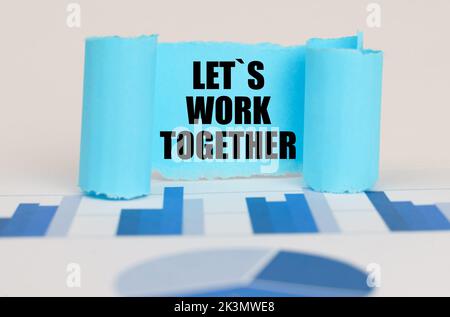 Business concept. On the blue diagram and graphs there is a twisted paper plate with the inscription - Let is Work Together Stock Photo