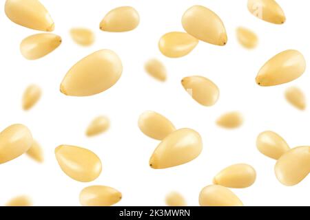 Falling Pine nuts isolated on white background, selective focus Stock Photo