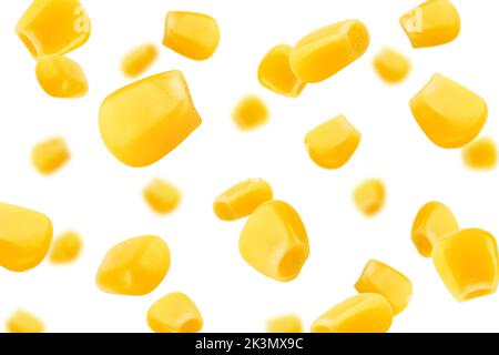 Falling corn seeds isolated on white background, selective focus Stock Photo