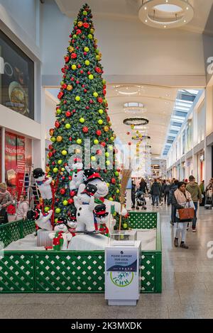 Dublin, November 2019 Christmas tree, snowman and decorations in Ilac Shopping Centre. People, families doing Christmas shopping Stock Photo