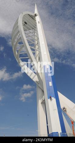 High roller Irina Gola has been making a splash with several thousands of litres of paint while she carries out a towering job with a difference – turning the tallest building outside London from white to blue and gold.     Irina is part of an army of painters drafted in to transform the 560ft high Spinnaker Tower in Port  smouth into the colours of new sponsors, Emirates Airlines.     The colouring has been the subject of controversy because the airline’s colours are gold and red and the tower was to have been painted red and gold until an online protest petition gathered 10,000 signatures. E Stock Photo