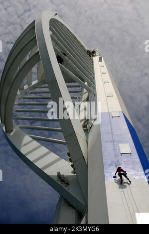 High roller Irina Gola has been making a splash with several thousands of litres of paint while she carries out a towering job with a difference – turning the tallest building outside London from white to blue and gold.     Irina is part of an army of painters drafted in to transform the 560ft high Spinnaker Tower in Port  smouth into the colours of new sponsors, Emirates Airlines.     The colouring has been the subject of controversy because the airline’s colours are gold and red and the tower was to have been painted red and gold until an online protest petition gathered 10,000 signatures. E Stock Photo