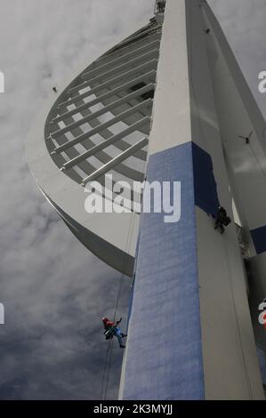 High roller Irina Gola has been making a splash with several thousands of litres of paint while she carries out a towering job with a difference – turning the tallest building outside London from white to blue and gold.     Irina is part of an army of painters drafted in to transform the 560ft high Spinnaker Tower in Port  smouth into the colours of new sponsors, Emirates Airlines.     The colouring has been the subject of controversy because the airline’s colours are gold and red and the tower was to have been painted red and gold until an online protest petition gathered 10,000 signatures. Stock Photo