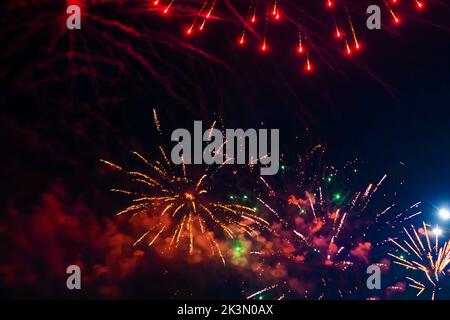 Beautiful multi-colored fireworks against the background of the night sky. High quality photo Stock Photo