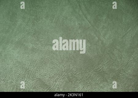 The texture of artificial leather. Background of black leather with patterns. Artificial material made of green leather. Stock Photo