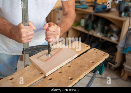 Senior carpenter working on wood craft. Professional tools for crafting. DIY maker and carpentry work concept. Stock Photo