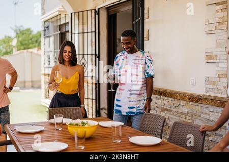 several friends sitting at a table to eat Stock Photo