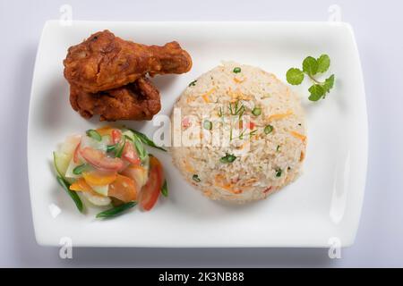 Schezwan Chicken Fried Rice in white bowl isolated on white background. Szechuan Rice is indo-chinese cuisine dish with bell peppers, green beans, car Stock Photo