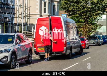 DPD delivery driver making a delivery in Llandudno, North Wales, UK. Stock Photo