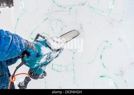 Making Christmas decorations. Master sculptor carves ice sculpture with ...