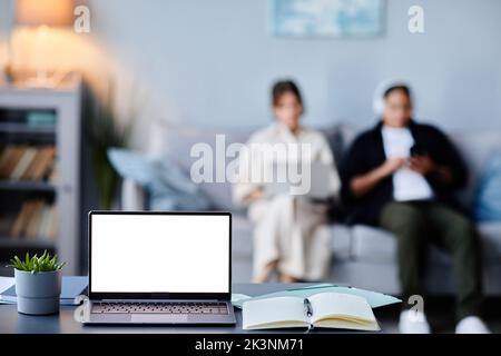 Background image of laptop with black white screen mockup in home interior with two women, copy space Stock Photo