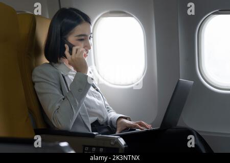 Fund investment woman confirm meeting to client before flight take off. working and travel concept Stock Photo