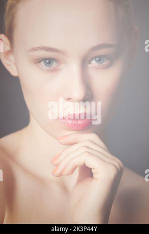 Mysterious beauty. Beauty shot of a young blond woman wearing red lipstick. Stock Photo