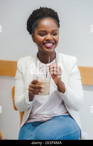 African american businesswoman drinking cocktail lemonade in cafe ...