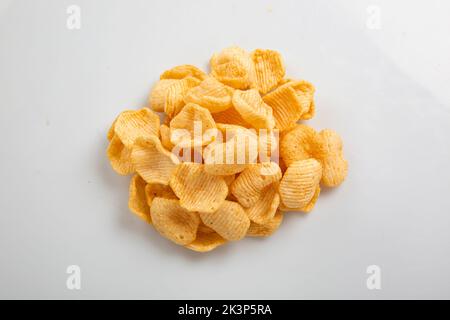 Potato chips falling into glass bowl isolated on white background with clipping path, flying potato crisps Stock Photo