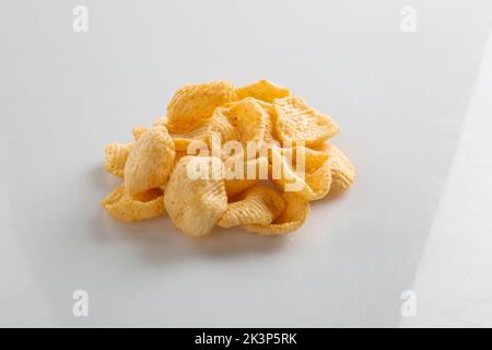 Potato chips falling into glass bowl isolated on white background with clipping path, flying potato crisps Stock Photo