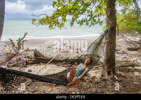 Enjoying a wild beach at the edge of Cabo Blanco Nature Reserve, Costa Rica Stock Photo