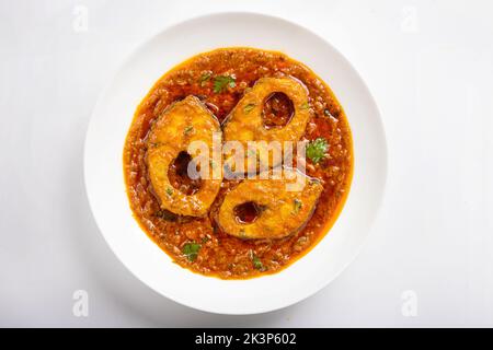 Ruhu rui or Katla  Fish curry, traditional bangali fish curry ,arranged in a white ceramic bowl garnished with fresh red chilly and curry leaves on a Stock Photo