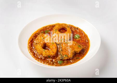 Ruhu rui or Katla  Fish curry, traditional bangali fish curry ,arranged in a white ceramic bowl garnished with fresh red chilly and curry leaves on a Stock Photo