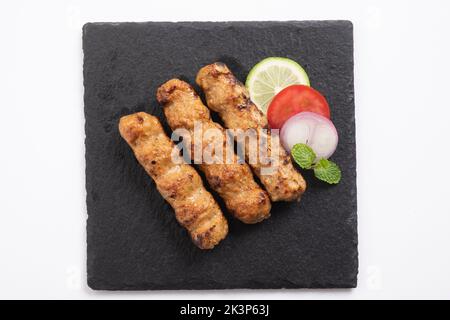 Seekh Kabab made with minced chicken or Mutton keema, served with green chutney and salad Stock Photo