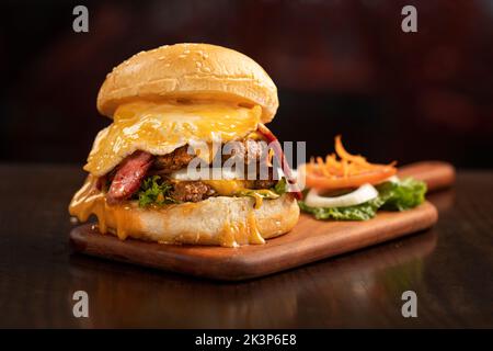 fresh tasty burger isolated on black texture background Stock Photo