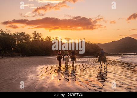 Horse riding on Playa Conchal, Guanacaste, Costa Rica Stock Photo