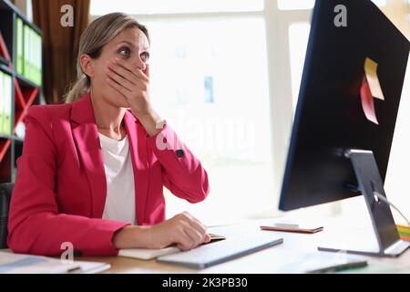 Shocked overwhelmed businesswoman looking at computer monitor Stock Photo