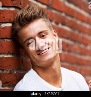 This is what handsome looks like. Portrait of a handsome young man standing outside. Stock Photo