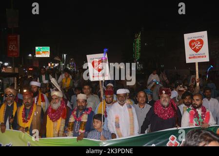 Lahore, Pakistan. 27th Sep, 2022. Pakistani faithful Muslims from a religious group Tehreek Minhaj Ul-Quran (PAT) attending a torch rally to welcome the month of Rabi Ul Awwal in connection with celebrations of Eid Milad-un-Nabi organized by Tehreek Minhaj Ul Quran Aziz Bhatti town in Lahore. President Shahbaz Hussain Qadri, Hammad Qadri, Subhani Qadri, and others lead the torch rally. (Photo by Rana Sajid Hussain/Pacific Press) Credit: Pacific Press Media Production Corp./Alamy Live News Stock Photo