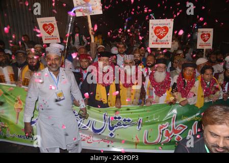 Lahore, Pakistan. 27th Sep, 2022. Pakistani faithful Muslims from a religious group Tehreek Minhaj Ul-Quran (PAT) attending a torch rally to welcome the month of Rabi Ul Awwal in connection with celebrations of Eid Milad-un-Nabi organized by Tehreek Minhaj Ul Quran Aziz Bhatti town in Lahore. President Shahbaz Hussain Qadri, Hammad Qadri, Subhani Qadri, and others lead the torch rally. (Photo by Rana Sajid Hussain/Pacific Press) Credit: Pacific Press Media Production Corp./Alamy Live News Stock Photo