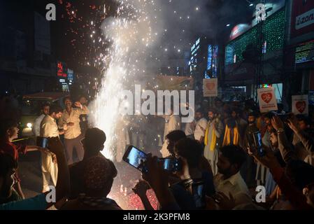 Lahore, Punjab, Pakistan. 27th Sep, 2022. Pakistani faithful Muslims from a religious group Tehreek Minhaj Ul-Quran (PAT) attending a torch rally to welcome the month of Rabi Ul Awwal in connection with celebrations of Eid Milad-un-Nabi organized by Tehreek Minhaj Ul Quran Aziz Bhatti town in Lahore. President Shahbaz Hussain Qadri, Hammad Qadri, Subhani Qadri, and others lead the torch rally. (Credit Image: © Rana Sajid Hussain/Pacific Press via ZUMA Press Wire) Stock Photo