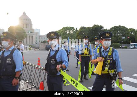 Tokyo, Japan. 27th Sep, 2022. Police officers control traffic and pedestrian crossing in front of the Japanese parliament. Demonstrators gathered in front of the National Diet Building (Tokyo) to express their dissatisfaction with the government's decision to give former Japanese Prime Minister Shinzo Abe a state funeral. They criticize the high costs and the late timing of the funeral. Credit: SOPA Images Limited/Alamy Live News Stock Photo