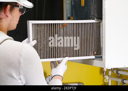Replacing filter in the central ventilation system. hvac filter replacing home central air system Stock Photo