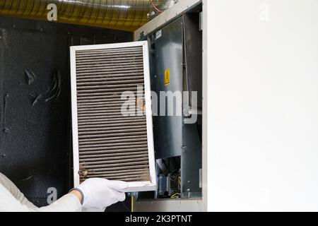 Replacing filter in the central ventilation system. hvac filter replacing home central air system Stock Photo