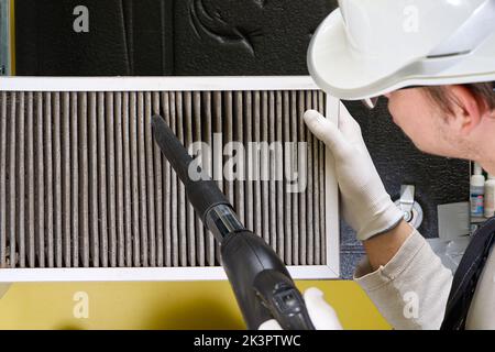 Replacing filter in the central ventilation system. hvac filter replacing home central air system Stock Photo