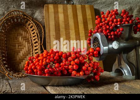 Bunches of red berries on a wooden board. Food close-up. Harvesting in autumn Stock Photo
