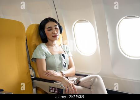 A Female Passenger Traveling by Plane Sleeping on Cushion Airplane