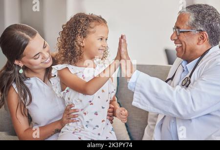 Family, medical and high five with girl and doctor in consulting hospital room for healthcare, trust and support. Communication, medicine and smile Stock Photo