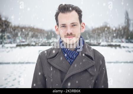 Portrait of a Caucasian handsome male with beard and moustache in winter snow Stock Photo
