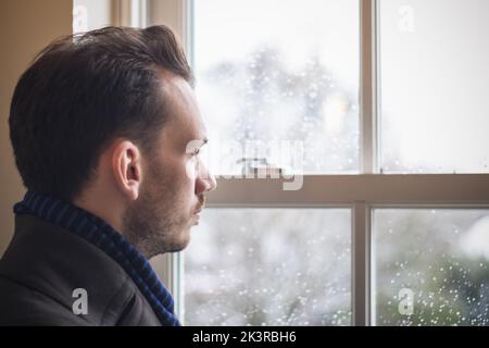 Portrait of a man looking out window Stock Photo