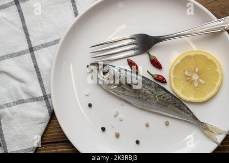 the raw common scad in the plate, The raw Atlantic horse mackerel in the dish Stock Photo