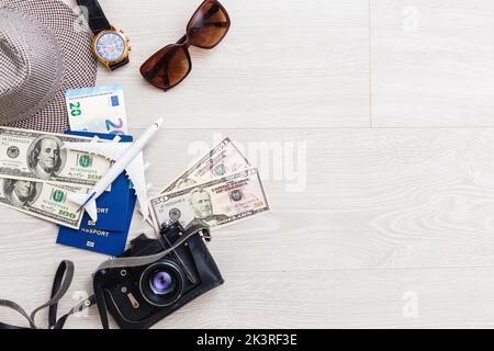 travel items are a compass, tickets, documents, money, a camera, a toy airplane. Planning of air travel, holidays, business trips. Advertising, banner Stock Photo