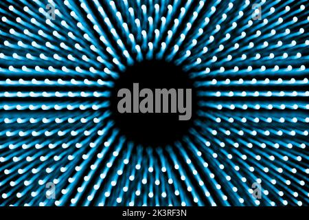 Abstract blue background of concentric glowing dots with blur Stock Photo