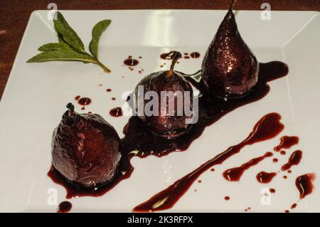 Pears in red wine bathed in their juice Stock Photo