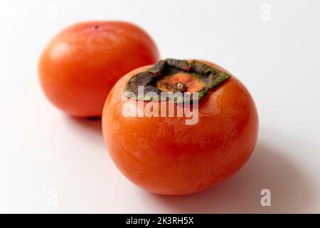 ripe persimmon on a white background Stock Photo
