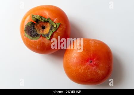 ripe persimmon on a white background Stock Photo