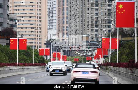 GUIYANG, CHINA - SEPTEMBER 28, 2022 - Five-star red flags are hung on a viaduct to welcome the upcoming National Day in Guiyang, Guizhou province, Chi Stock Photo