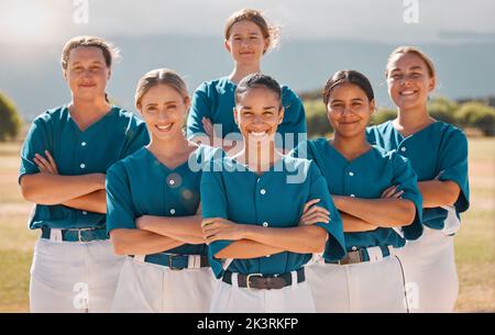 Baseball, happy and women team with arms crossed on a sport field after practice or a game. Teamwork, collaboration and support with a proud group of Stock Photo