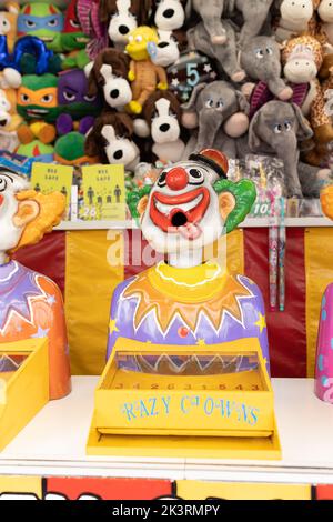 Laughing clowns game attraction at a fair carnival Stock Photo